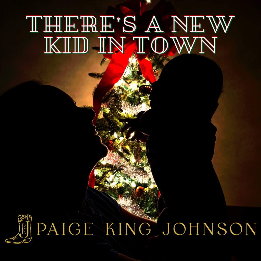 Paige King Johnson holds her son Wyatt beside a Christmas tree on the Theres A New Kid In Town cover