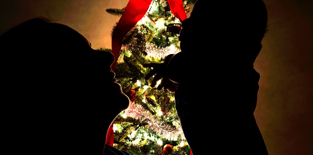 Paige King Johnson holds her son Wyatt beside a Christmas tree on the Theres A New Kid In Town cover