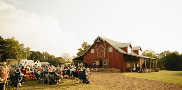 Fans gather beside the red barn at By Faith Farm in Joelton, Tennessee