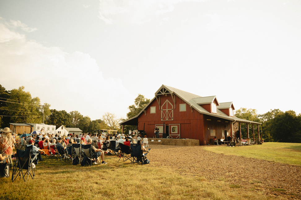 Fans gather beside the red barn at By Faith Farm in Joelton, Tennessee