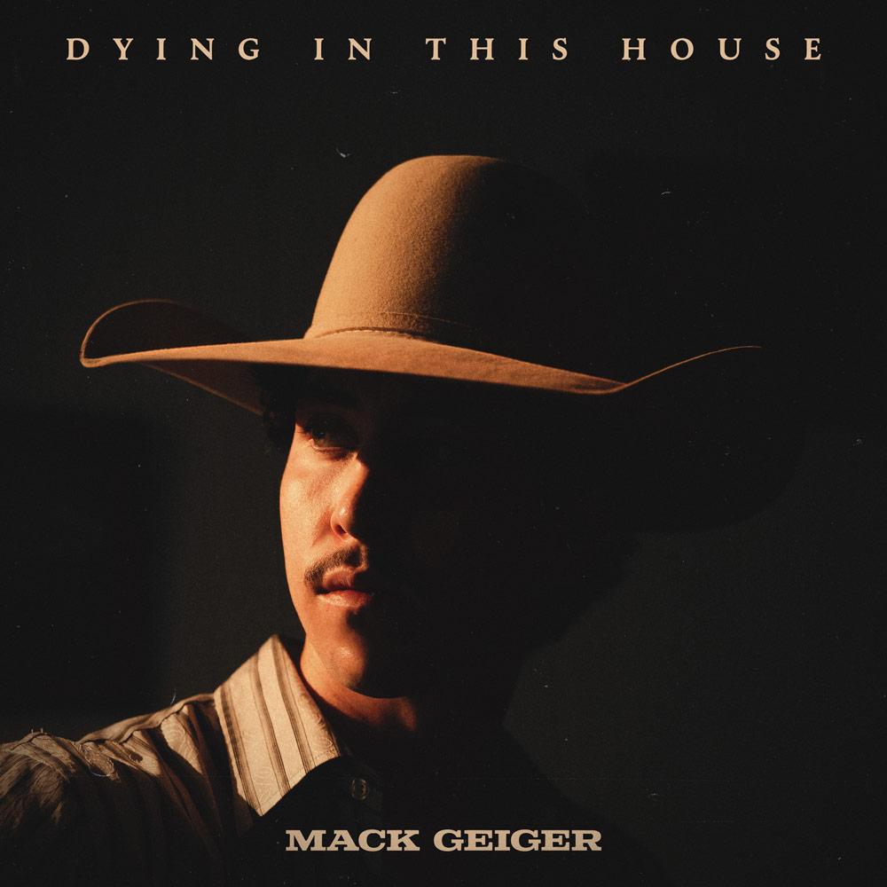 Mack Geiger wearing a cowboy hat on the Dying In This House album cover