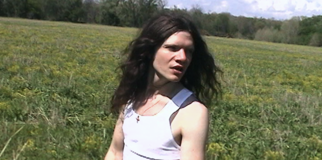 Sawyer Hill outdoors in a field in the Lady Arkansas music video